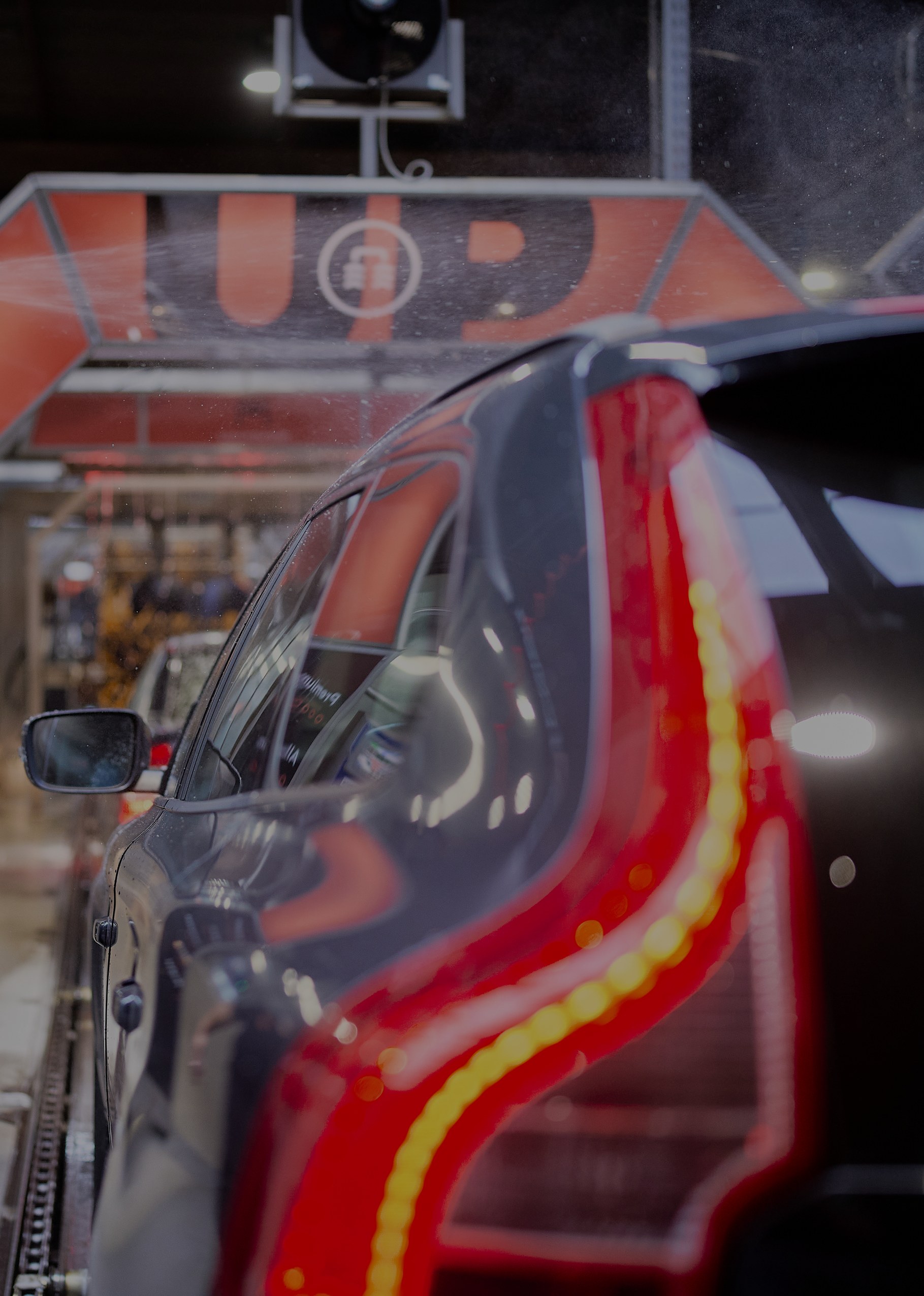 Een auto rijdt de wasstraat van UP Carwash in